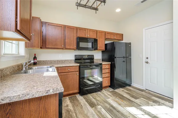 a kitchen with a sink stove and refrigerator