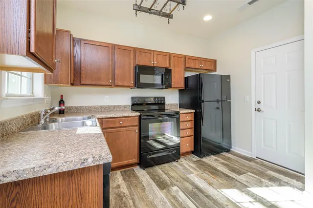 a kitchen with a sink stove and refrigerator