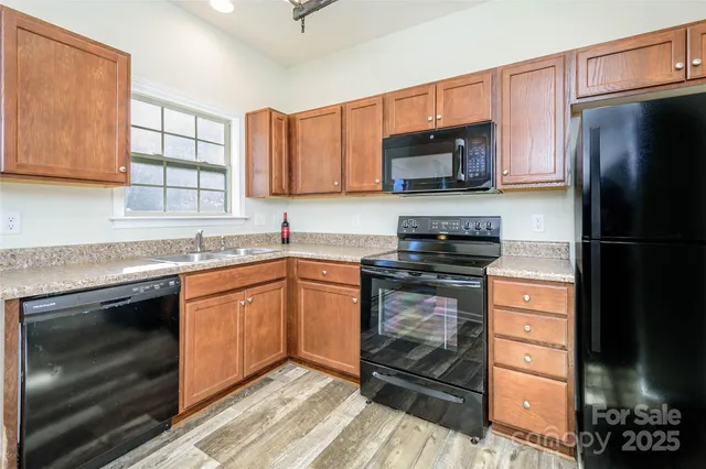 a kitchen with stainless steel appliances granite countertop a stove microwave and refrigerator