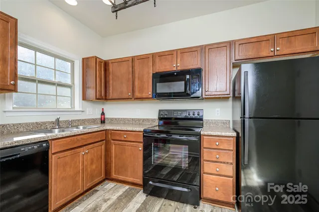 a kitchen with a sink stove and microwave