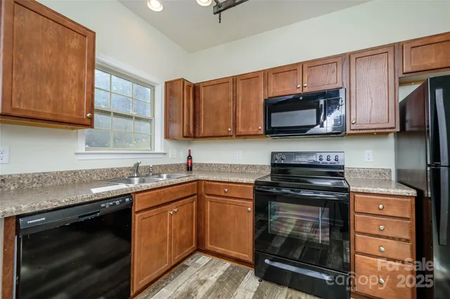 a kitchen with a sink stove and microwave