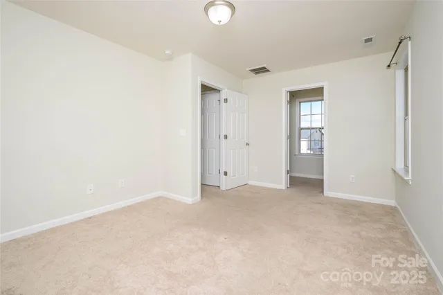 a spacious bathroom with a tub sink and mirror
