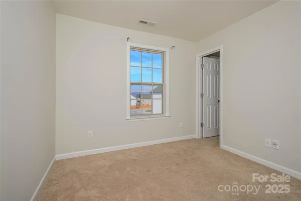 an empty room with an entrance to other room