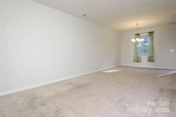 an empty room with windows and entrance