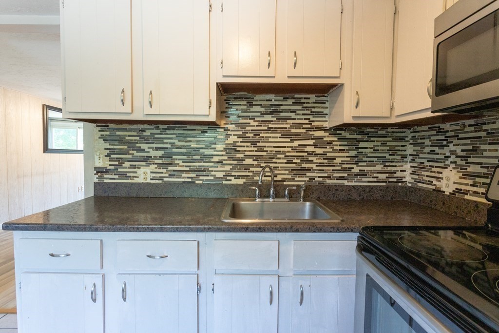 11 Tideview Path, Unit 17 Plymouth, MA 02360 - Photo 1 of 20 a kitchen with granite countertop white cabinets and a stove