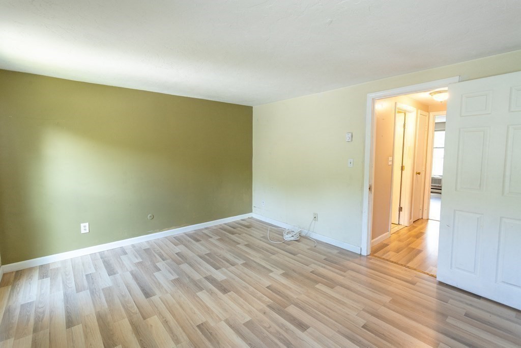 11 Tideview Path, Unit 17 Plymouth, MA 02360 - Photo 18 of 20 an empty room with wooden floor and windows