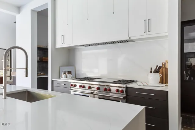 a kitchen with stainless steel appliances a sink and a stove top oven