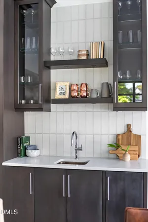 a bedroom with furniture and large windows