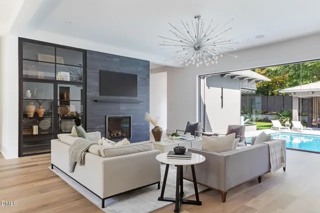 a kitchen with a dining table chairs cabinets and stainless steel appliances