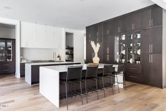a kitchen with a table chairs and a stove