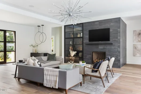 a living room with furniture and large windows