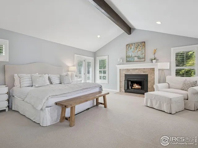 a spacious bedroom with a bed and a window