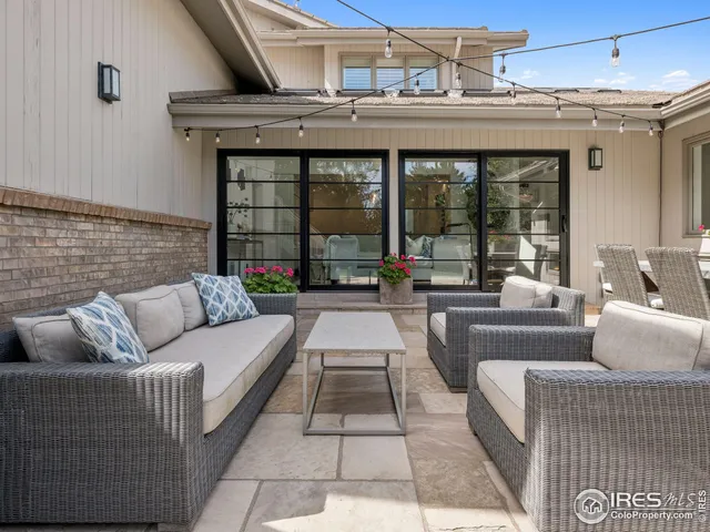a view of a house with patio and a yard