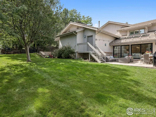 a house view with a sitting space and garden