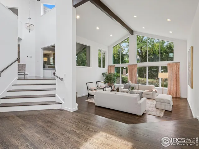 a living room with furniture and large windows