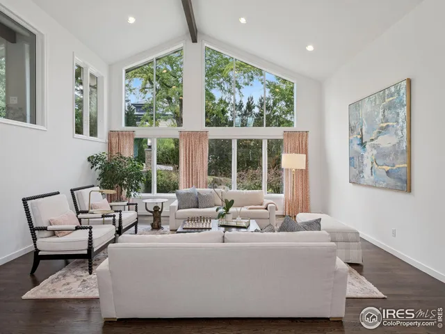 a living room with furniture and large windows
