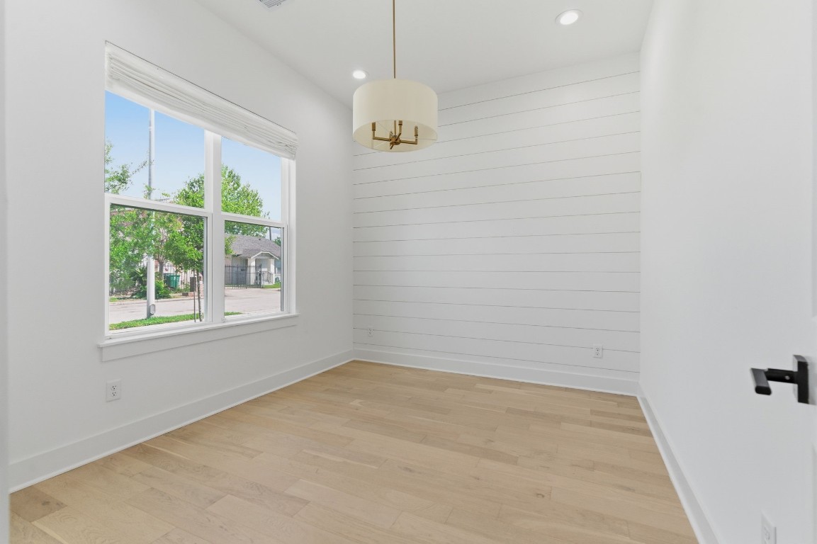 1005 Walton Street Houston, TX 77009 - Photo 5 of 36 1st Floor Study has wood floors and a shiplap accent wall. Large window overlooks the front yard.