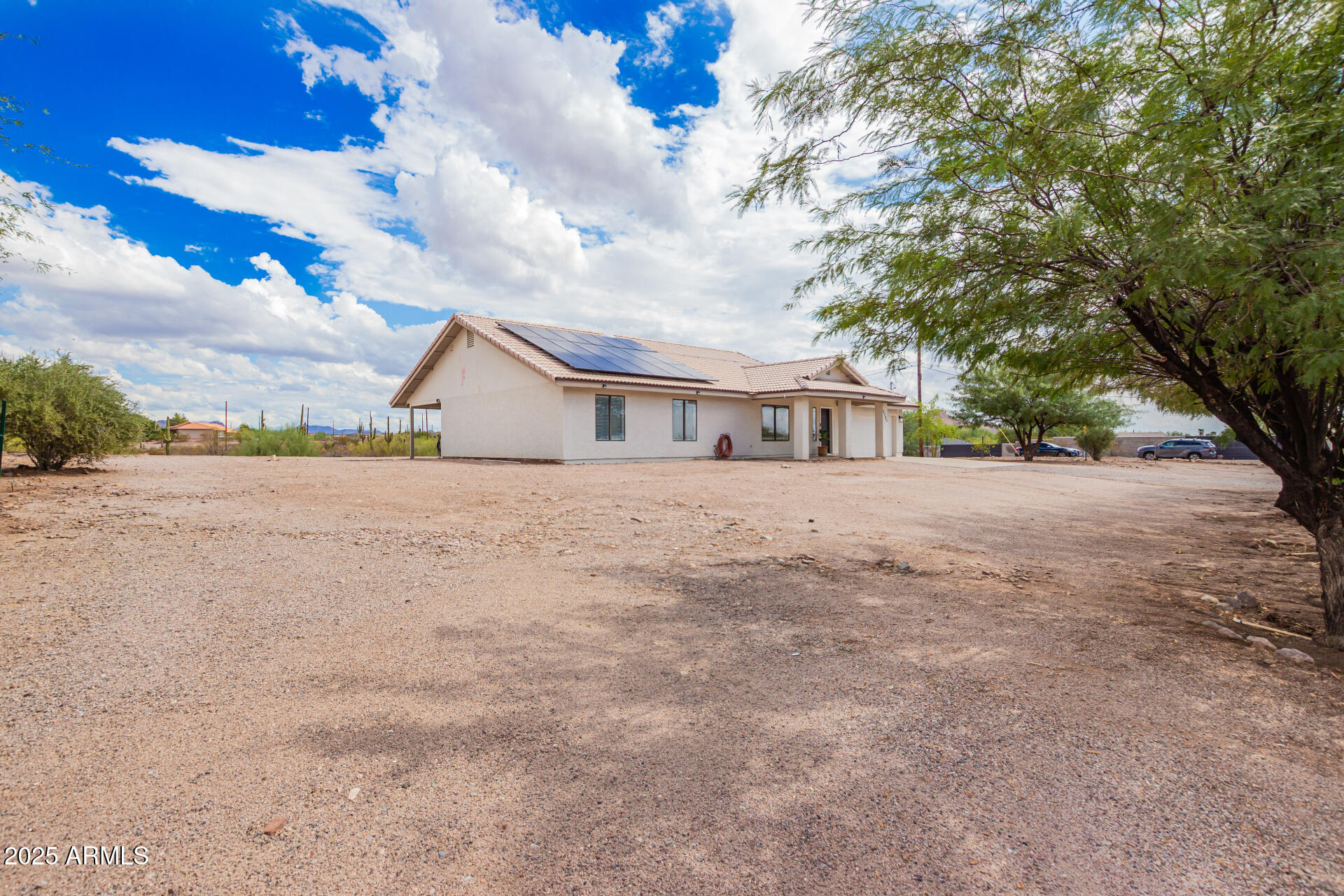 1737 South Mountain View Road Apache Junction, AZ 85119 - Photo 19 of 25 a view of house with yard and trees in the background