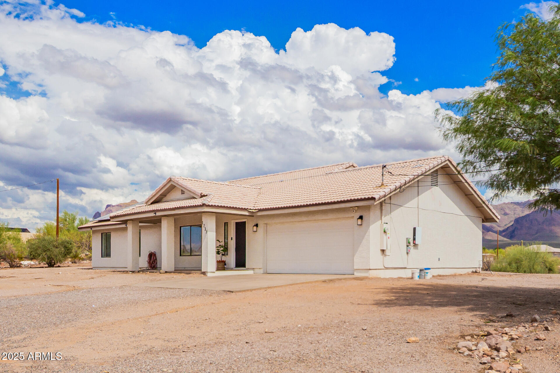 1737 South Mountain View Road Apache Junction, AZ 85119 - Photo 20 of 25 a view of a white house next to a road and yard