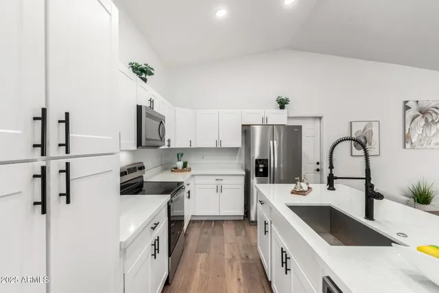 a kitchen with a sink stove and refrigerator