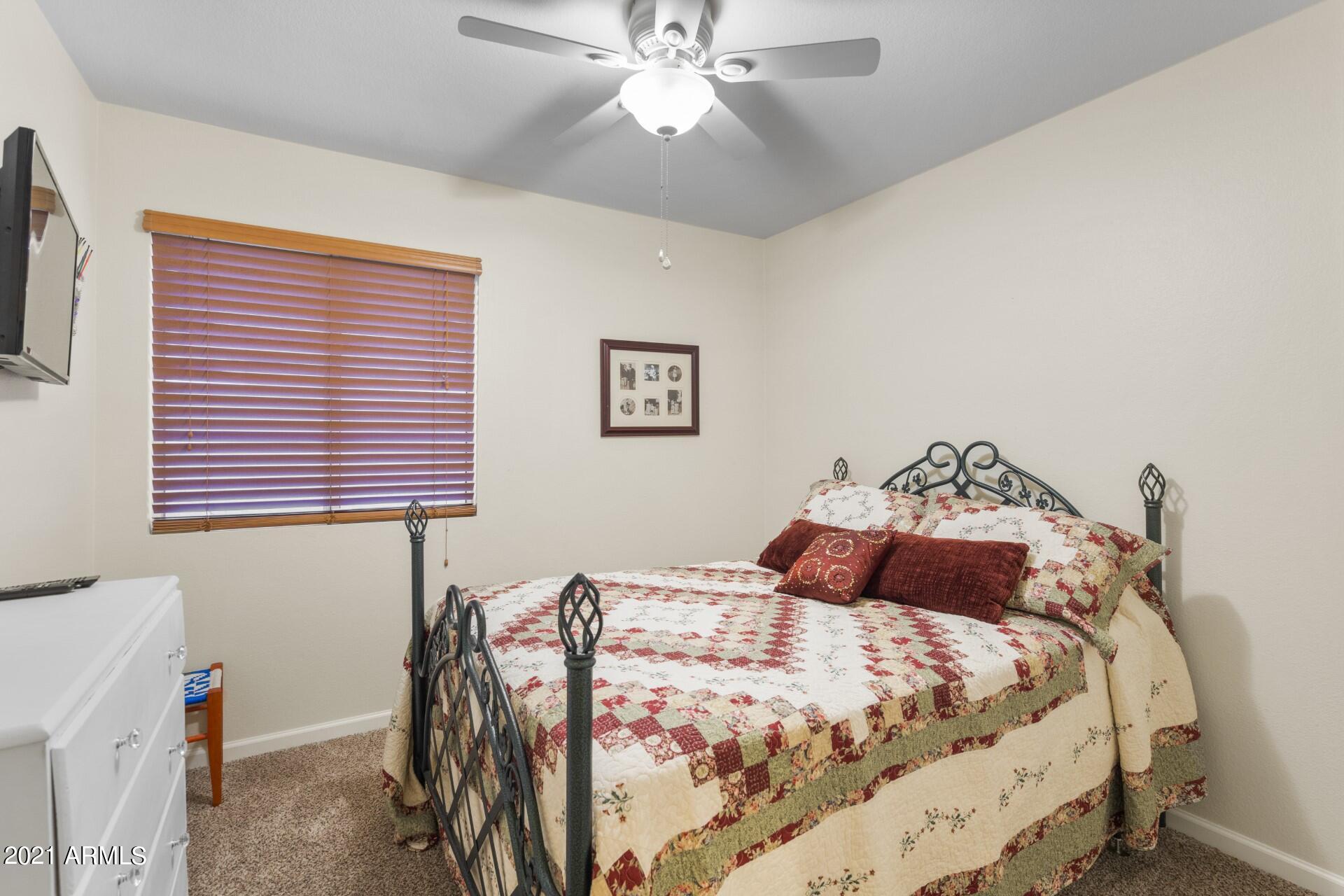 4161 West Bloomfield Road Phoenix, AZ 85029 - Photo 24 of 36 a bedroom with a bed and a chandelier