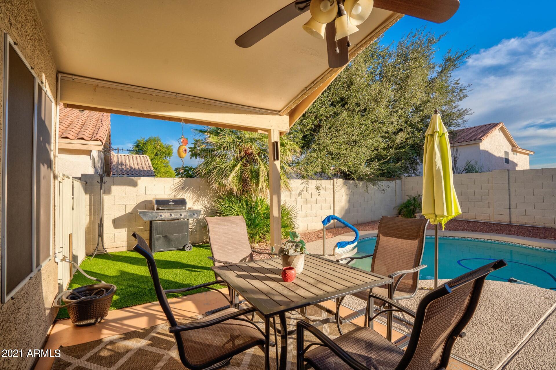 4161 West Bloomfield Road Phoenix, AZ 85029 - Photo 28 of 36 a view of a patio with table and chairs potted plants with floor to ceiling window and potted plants