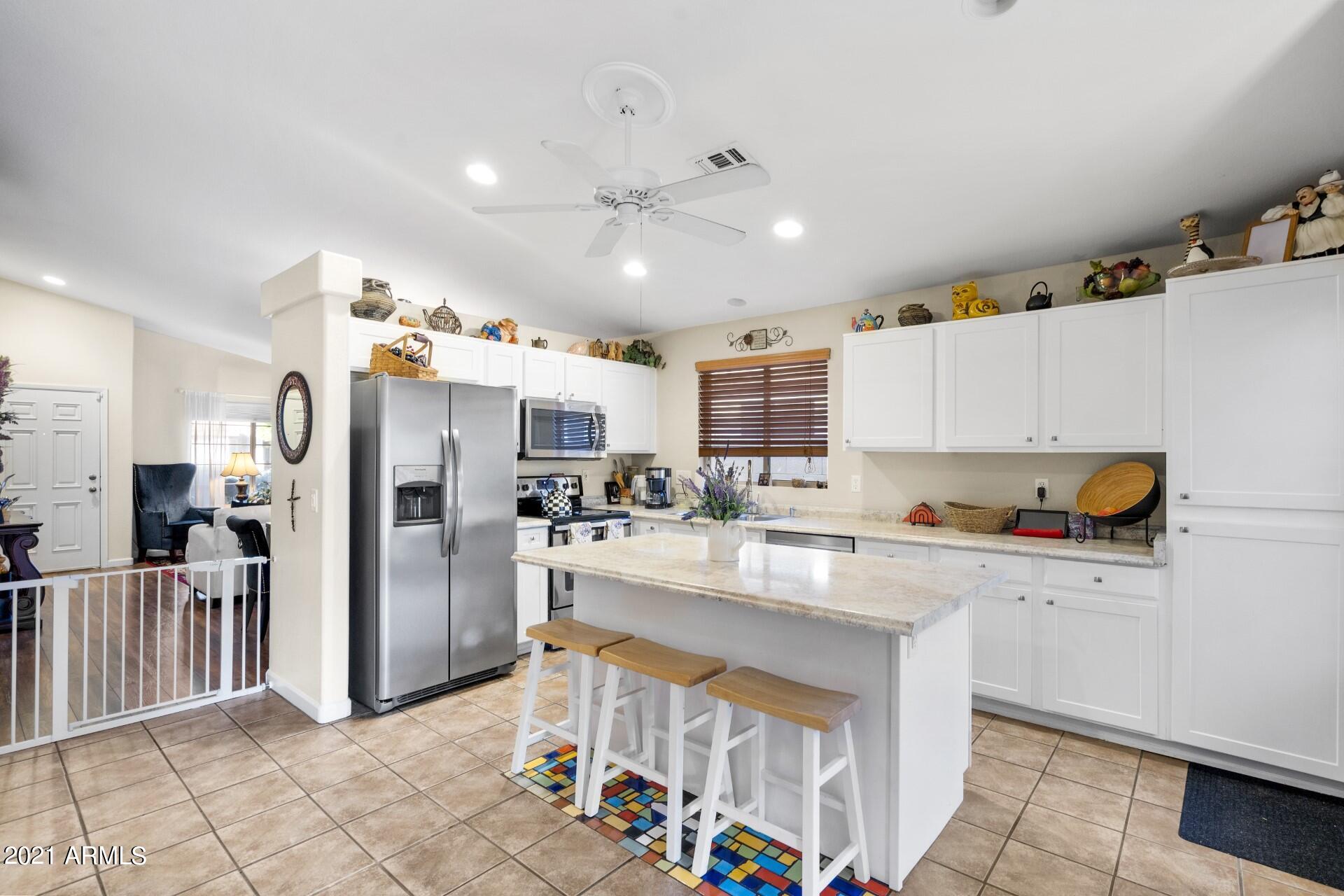 4161 West Bloomfield Road Phoenix, AZ 85029 - Photo 10 of 36 a kitchen with stainless steel appliances a refrigerator and a stove top oven
