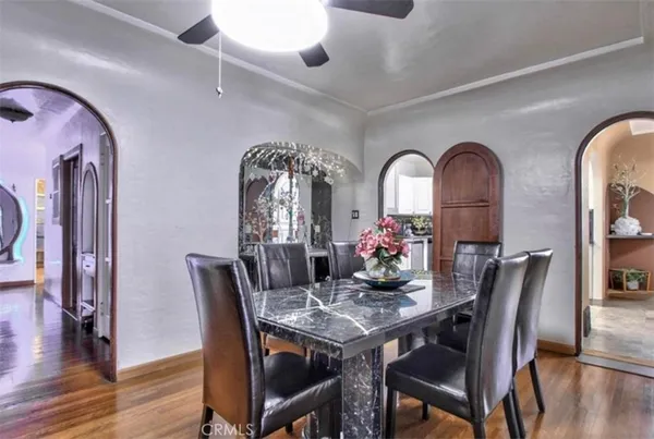 a view of a dining room with furniture and wooden floor
