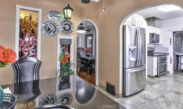 a kitchen with stainless steel appliances granite countertop a refrigerator and a stove
