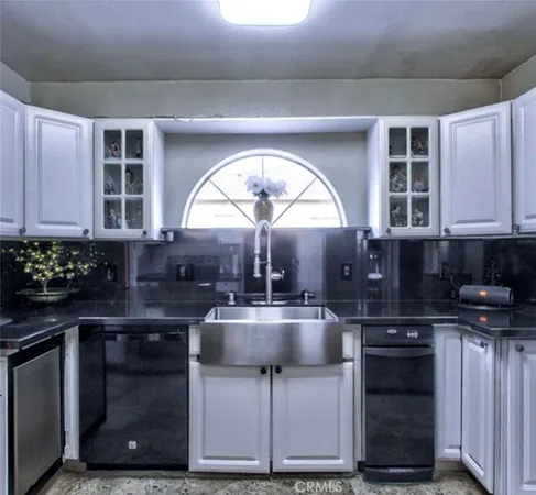 a kitchen with a stove a sink and a microwave