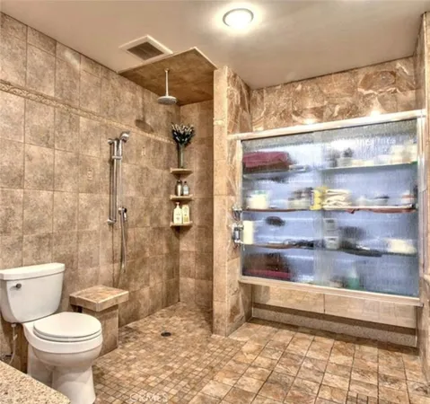 a bathroom with a toilet and a shower