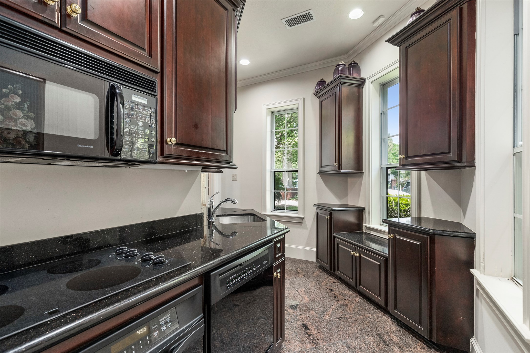 46 South Windsail Place The Woodlands, TX 77381 - Photo 17 of 47 a kitchen with stainless steel appliances granite countertop a stove and a microwave