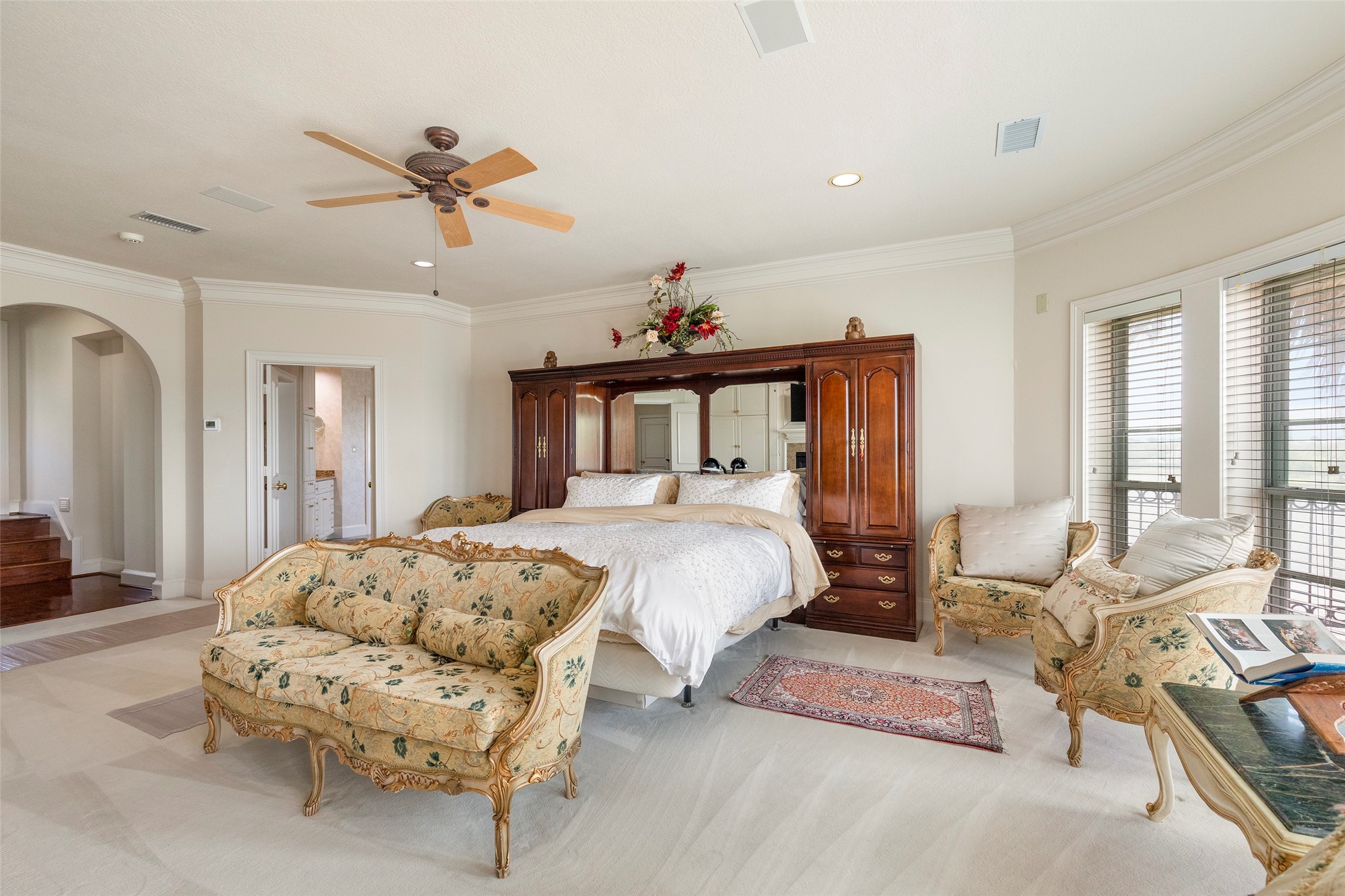 46 South Windsail Place The Woodlands, TX 77381 - Photo 22 of 47 a bed room with a bed and a chandelier