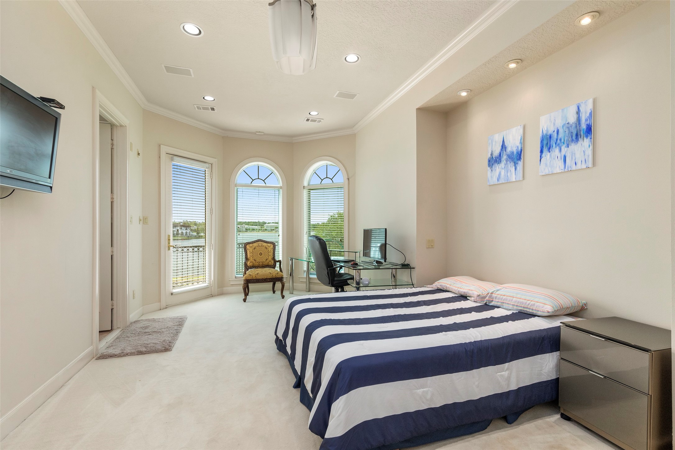 46 South Windsail Place The Woodlands, TX 77381 - Photo 28 of 47 a bedroom with a bed and a flat screen tv