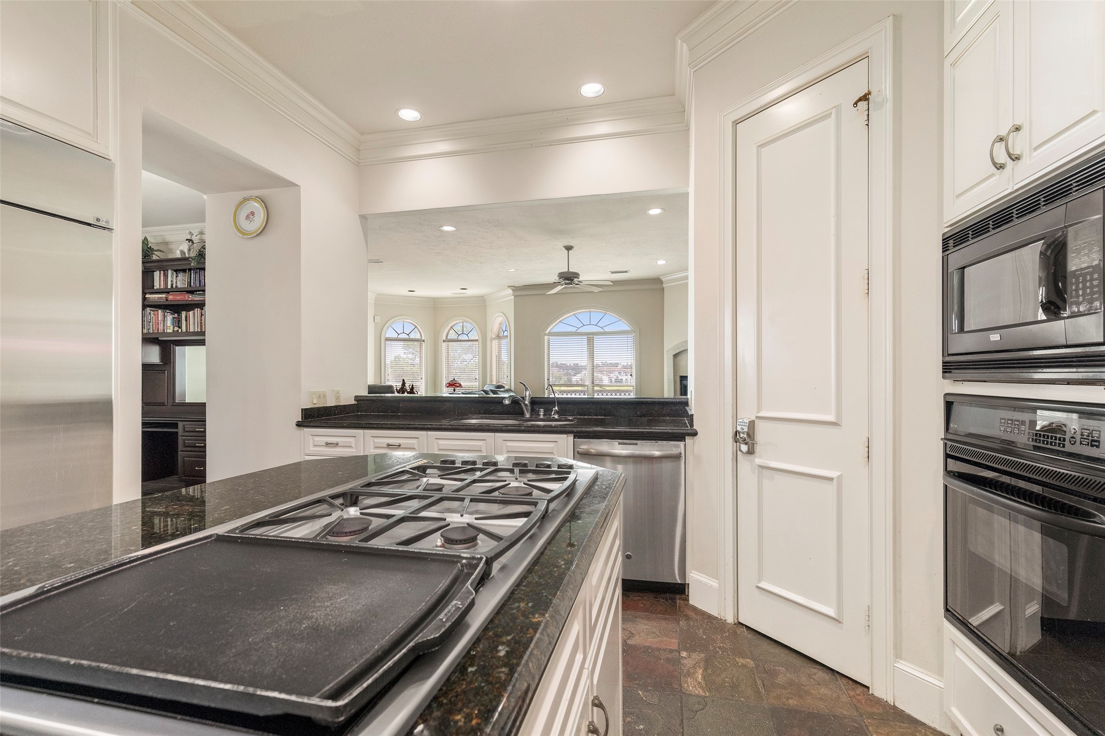 46 South Windsail Place The Woodlands, TX 77381 - Photo 32 of 47 a kitchen with stainless steel appliances granite countertop a refrigerator and a stove