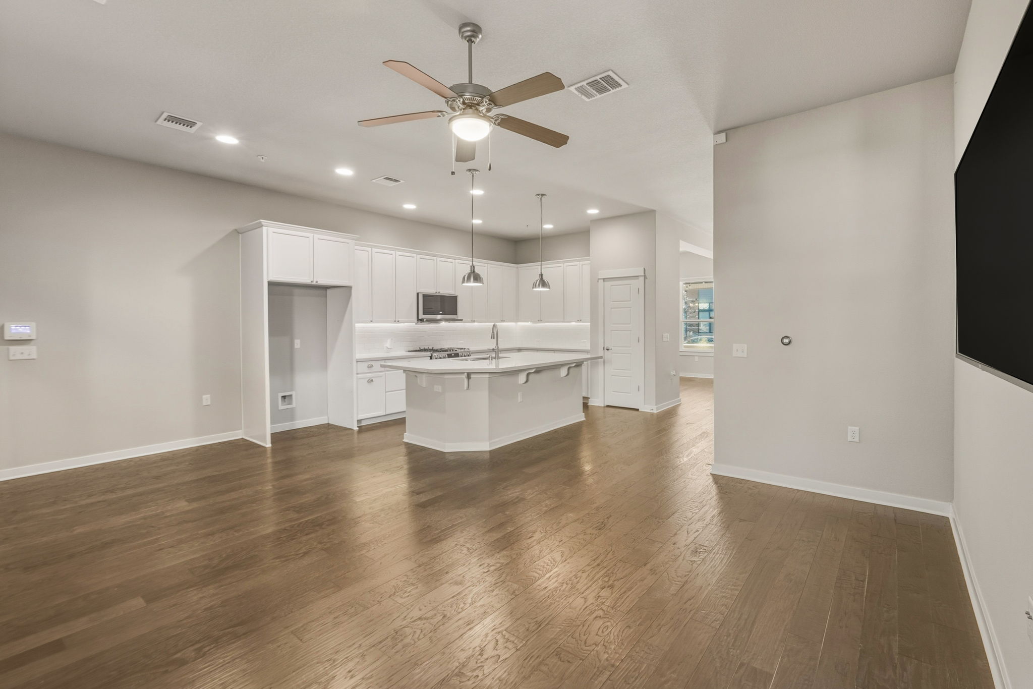 3919 Vaughan Street Austin, TX 78723 - Photo 15 of 40 Unfurnished living room with ceiling fan, dark wood-style flooring, and recessed lighting