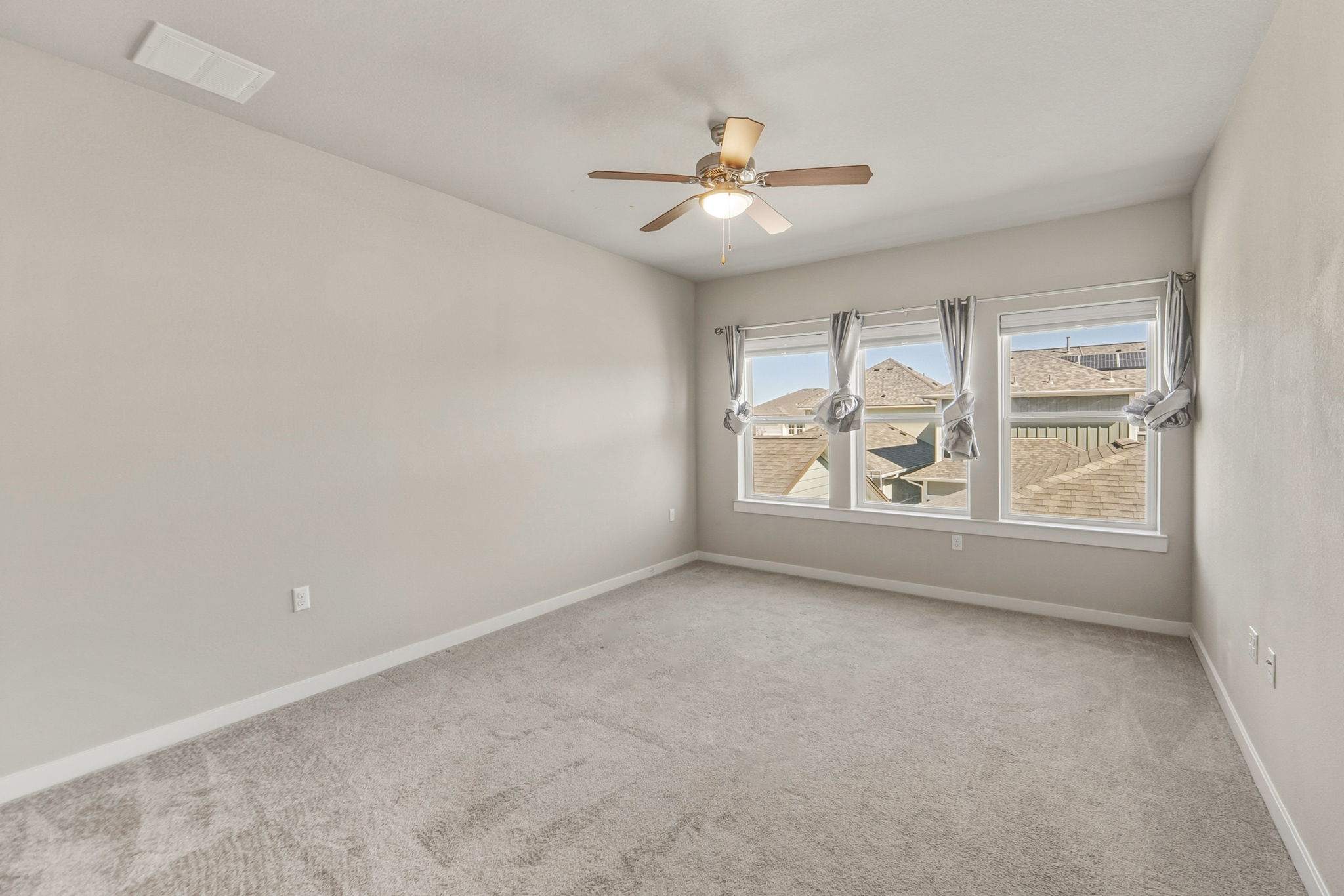 3919 Vaughan Street Austin, TX 78723 - Photo 18 of 40 Unfurnished room featuring carpet and a ceiling fan