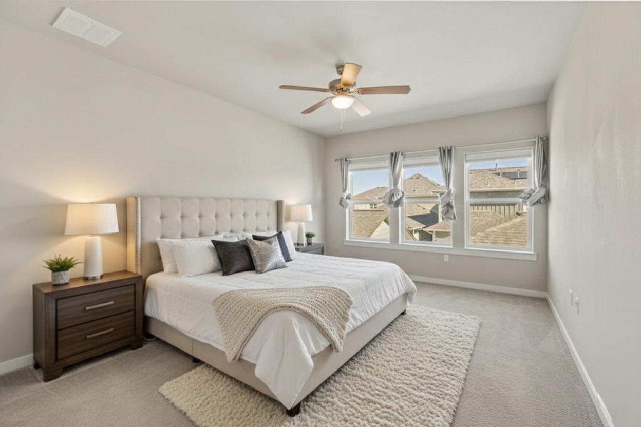 3919 Vaughan Street Austin, TX 78723 - Photo 21 of 40 Bedroom featuring light carpet and a ceiling fan