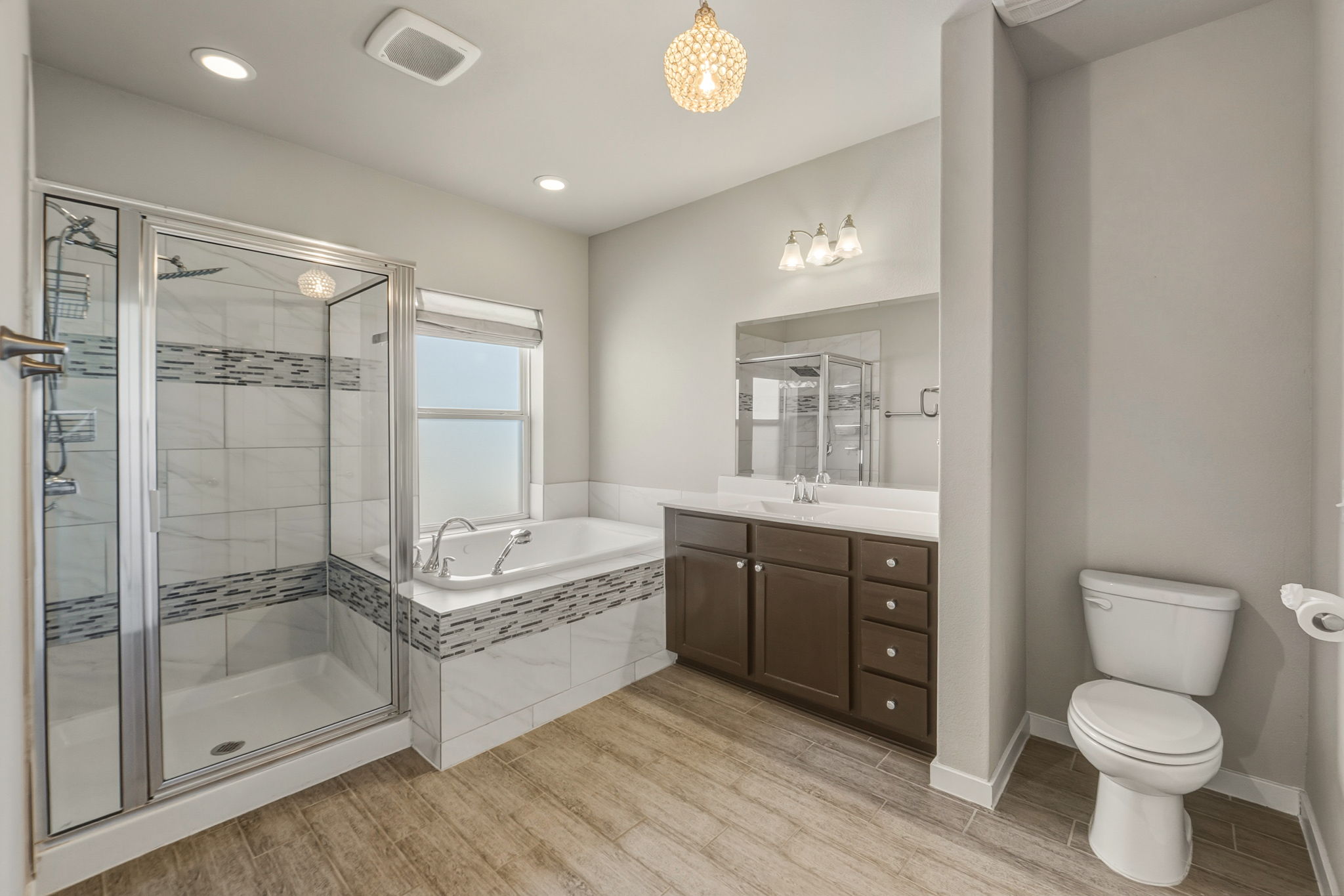 3919 Vaughan Street Austin, TX 78723 - Photo 22 of 40 Bathroom with a shower stall, a garden tub, vanity, light wood-style floors, and recessed lighting