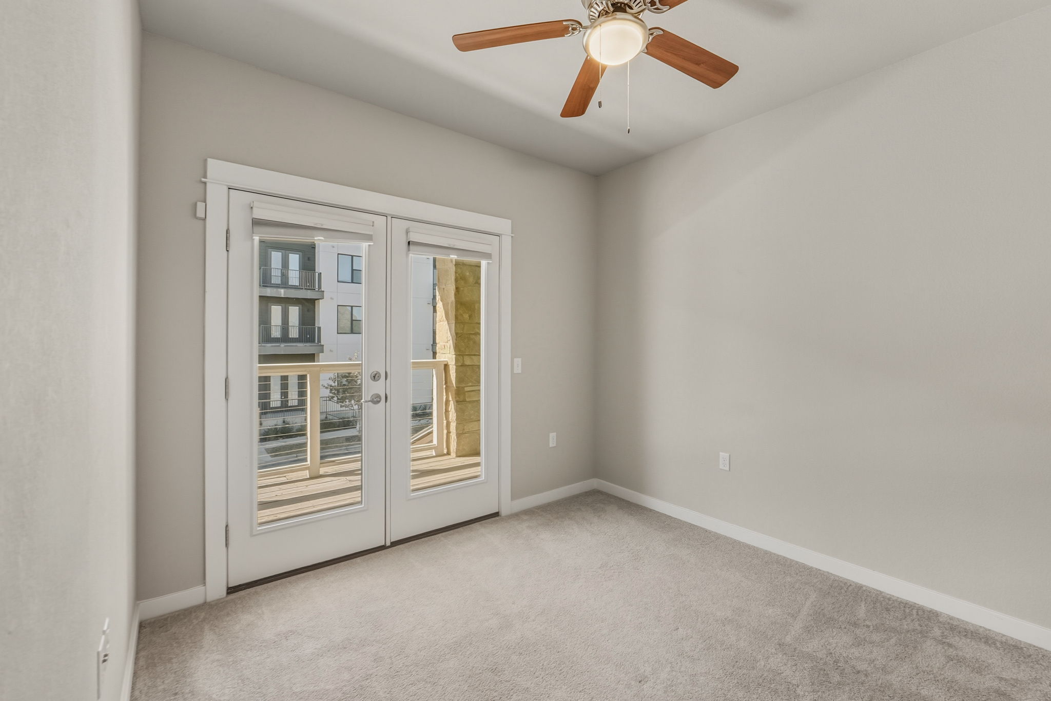 3919 Vaughan Street Austin, TX 78723 - Photo 28 of 40 Empty room featuring french doors, light carpet, and ceiling fan