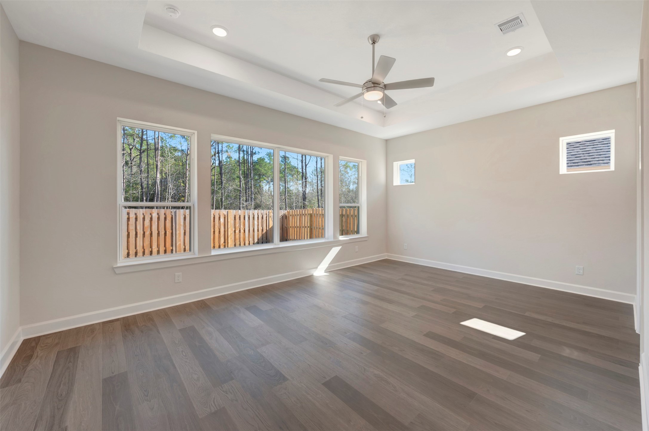 1728 Howler Way Montgomery, TX 77316 - Photo 15 of 43 Spacious Master suite with treyed ceiling and lots of windows for light plus low maintenance vinyl plank floors!