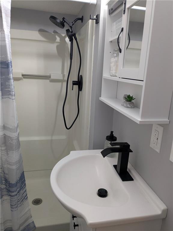 7 7th Street Bessemer, PA 16112 - Photo 11 of 24 a bathroom with a sink and mirror