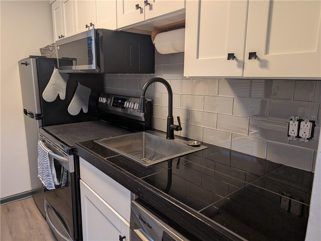 7 7th Street Bessemer, PA 16112 - Photo 5 of 24 a close view of a sink and dishwasher in kitchen