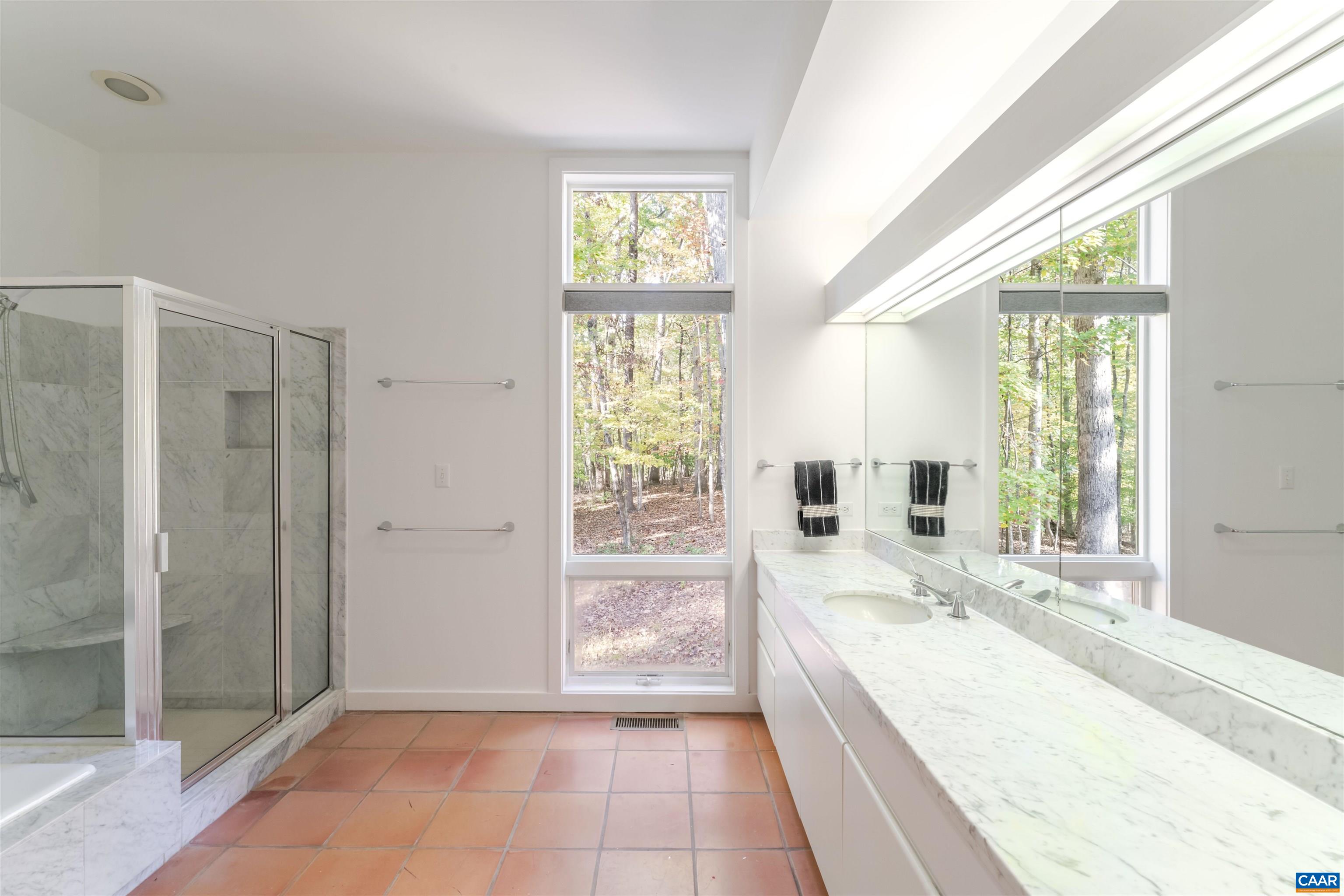 2990 Beau Mont Farm Road Charlottesville, VA 22901 - Photo 18 of 38 a large bathroom with a tub shower and sink