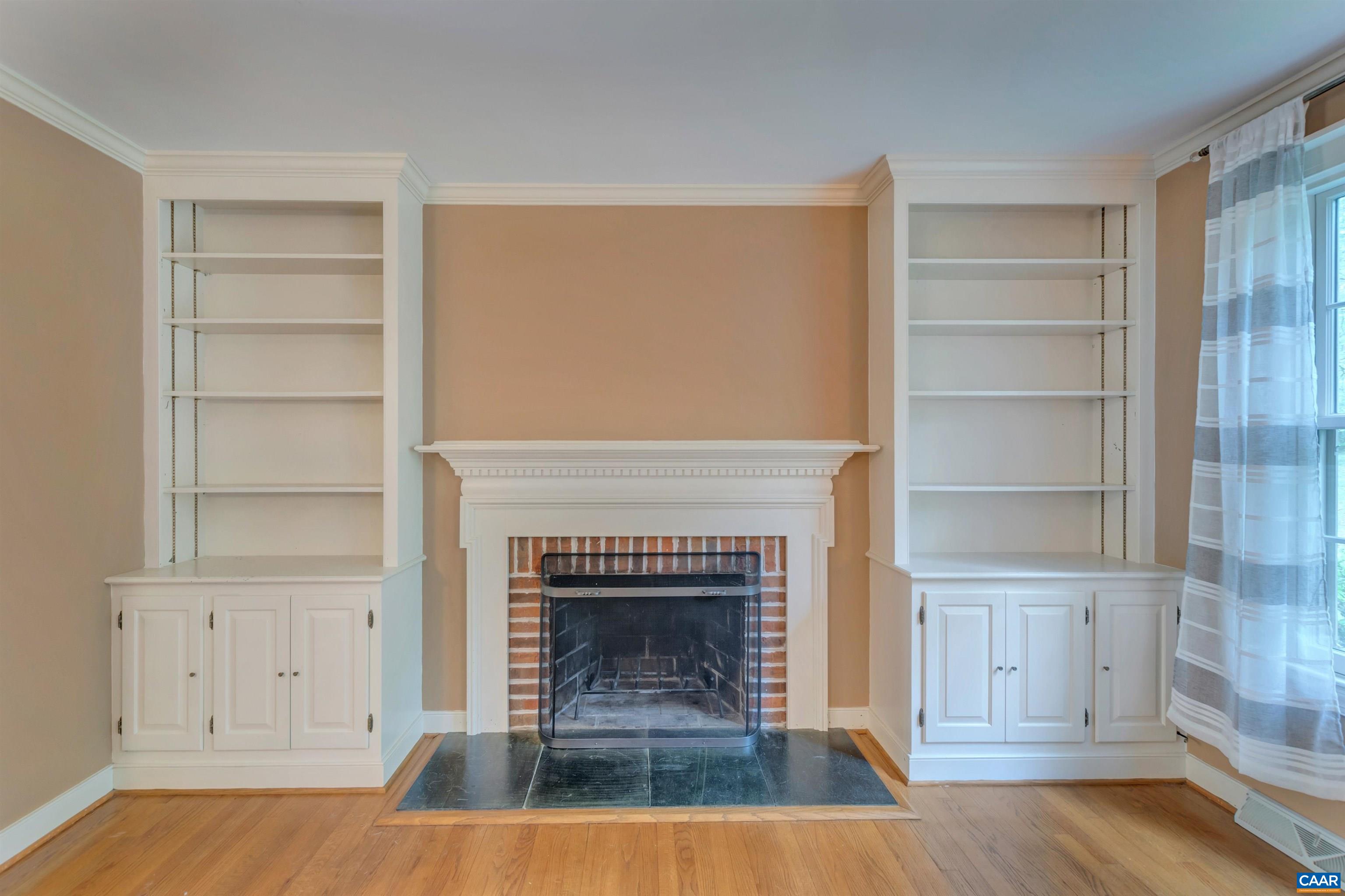 2460 Dunmore Road Charlottesville, VA 22901 - Photo 41 of 41 a living room with a fireplace and wooden floor