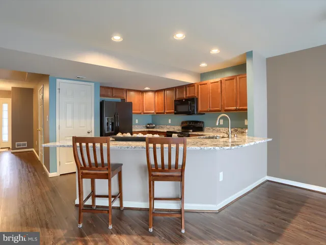 a kitchen with a table chairs sink and cabinets