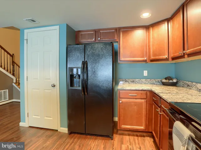 a kitchen with stainless steel appliances granite countertop a refrigerator and a sink