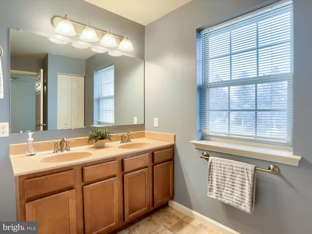 a bathroom with a sink and a window