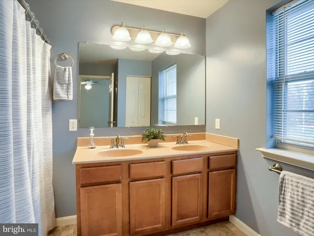 a bathroom with a double vanity sink and a mirror