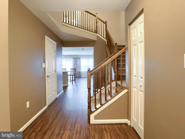 a view of entryway with wooden floor and stairs